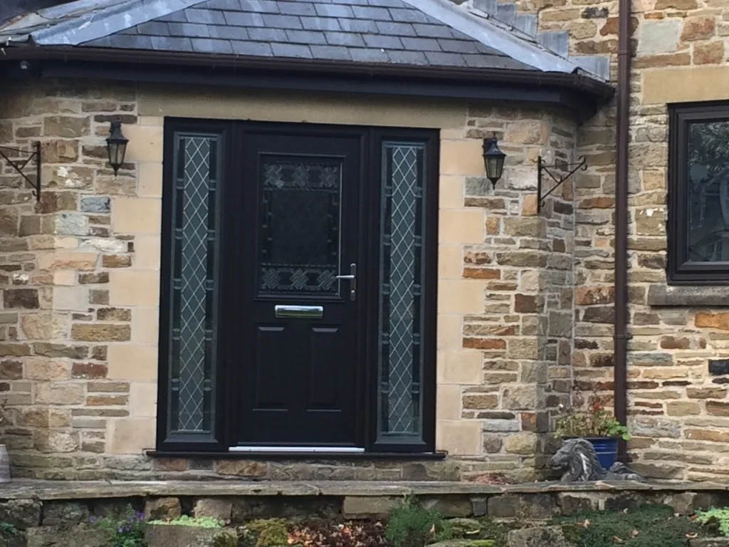Dark entrance door set into a stone facade