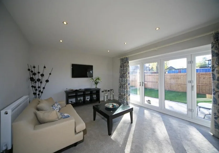 Light-filled living room with patio doors at Barton Road